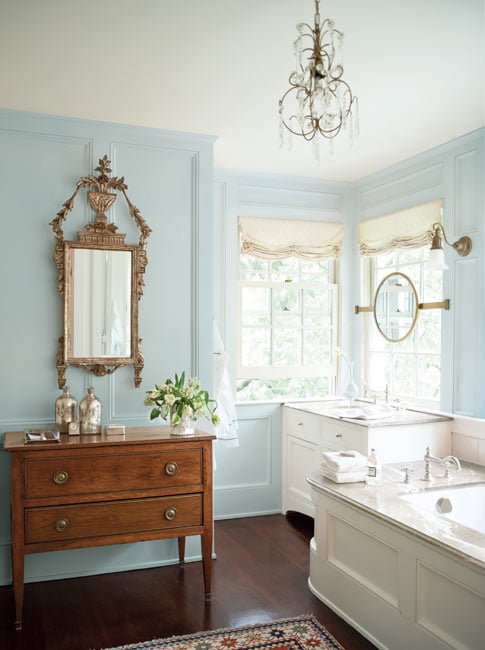 Benjamin Moore’s Breath of Fresh Air in an elegant bath with antiques