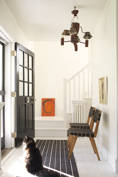 Entryway with Benjamin Moore Coventry Gray walls, stairs and trim in BM Super White; door in  Black 2132-10