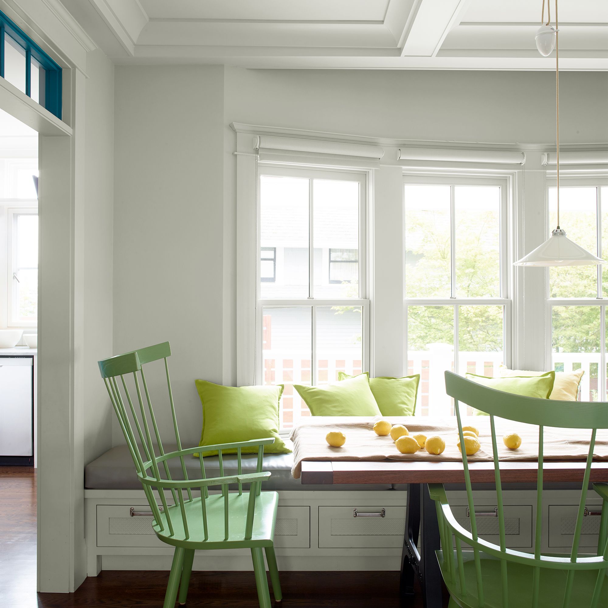 Benjamin Moore Gray Owl dining room walls enhanced by bright citrus-green chairs.