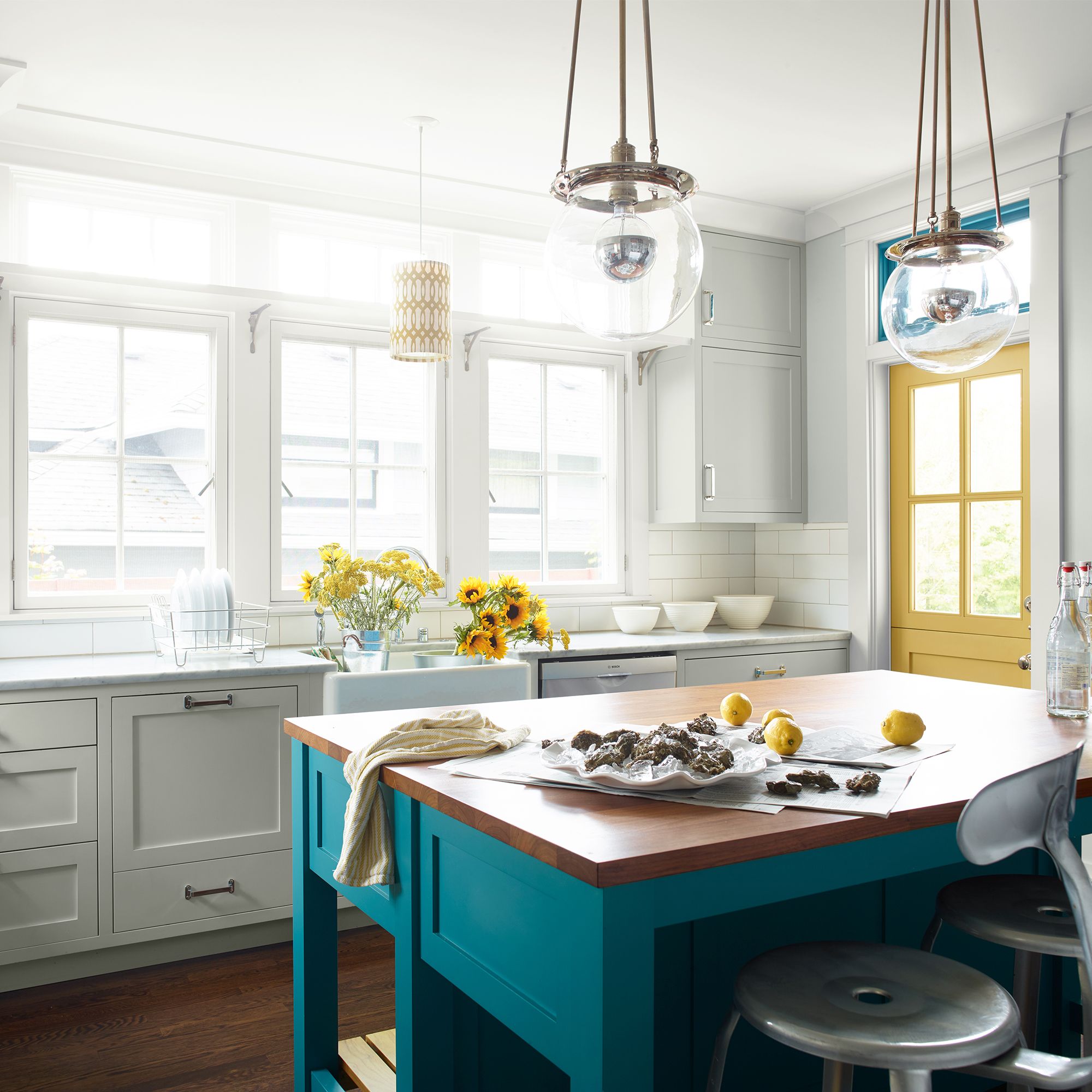 Benjamin Moore Owl Gray OC-52 kitchen cabinetry with a turquoise island and yellow accents