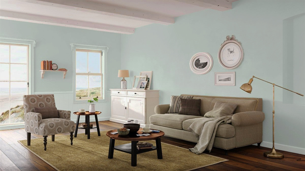 Benjamin Moore Beach Glass HC-1564 complements seaside views in the living room of a coastal cottage.