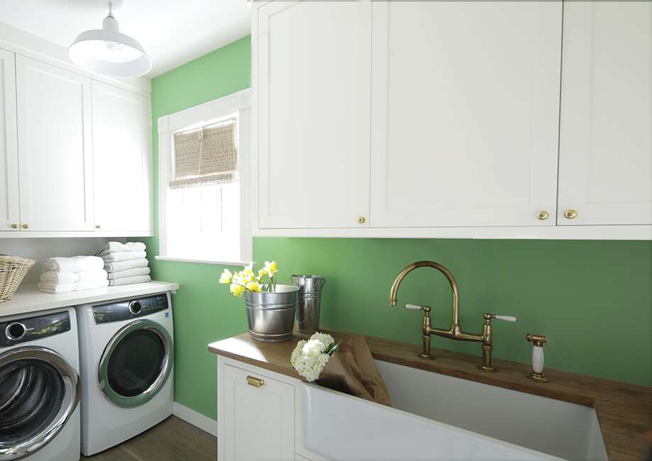 Laundry room cabinets in Benjamin Moore ADVANCE Satin in Super White; trim in ADVANCE Semi-Gloss in Super White; walls in Benjamin Moore Cedar Green