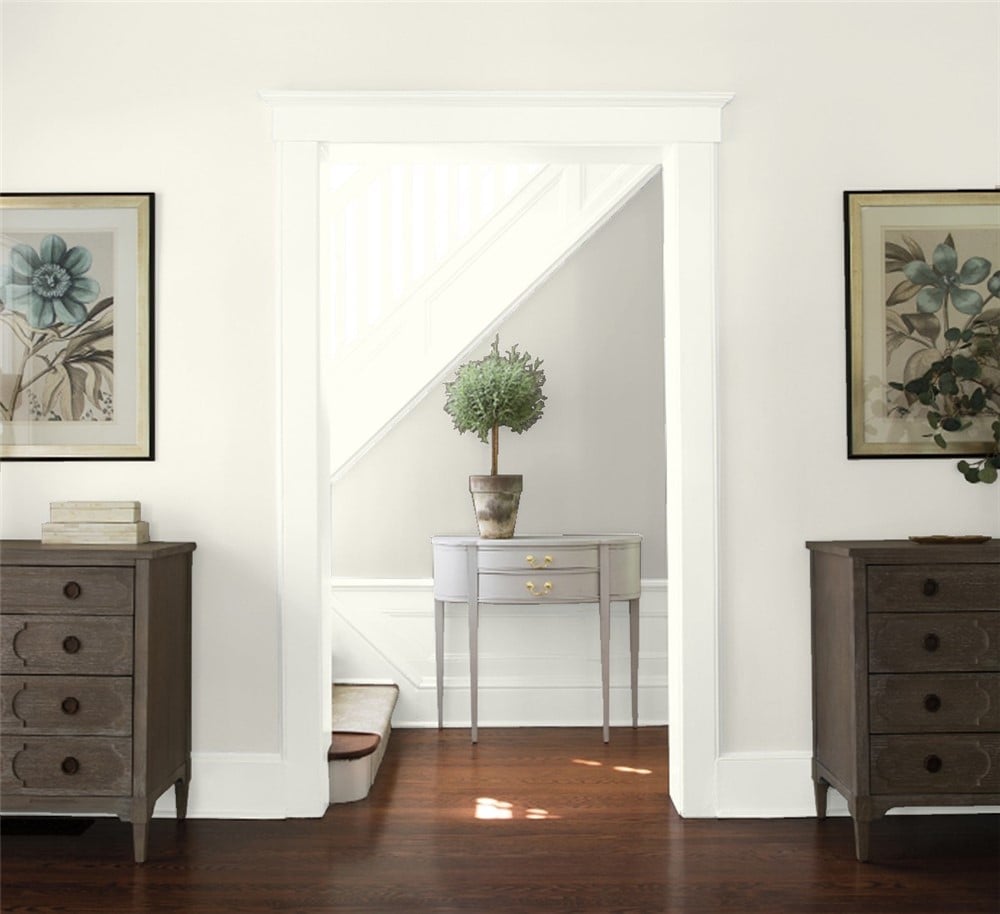 Benjamin Moore Swiss Coffee living room wall, Simply White trim, and Light Pewter on the stair wall.