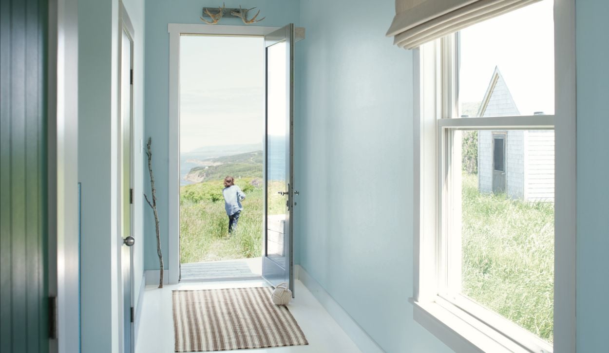 Hallway and entryway painted in Benjamin Moore Breath of Fresh Air, with trim in Benjamin Moore White Dove OC-17