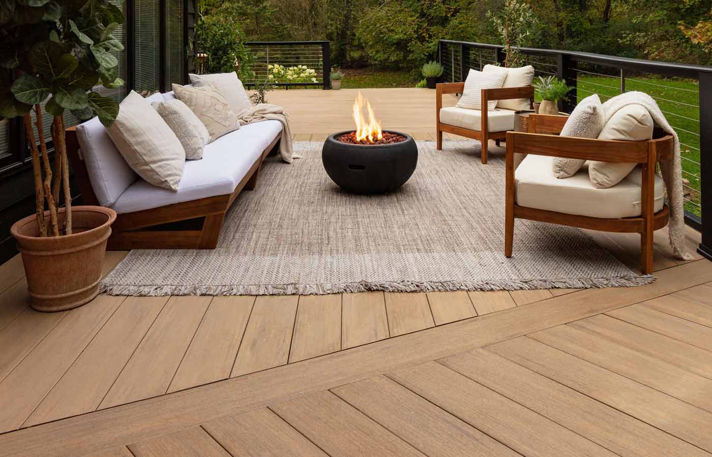 Outdoor sitting space with firepit featuring engineered decking from TimberTech
