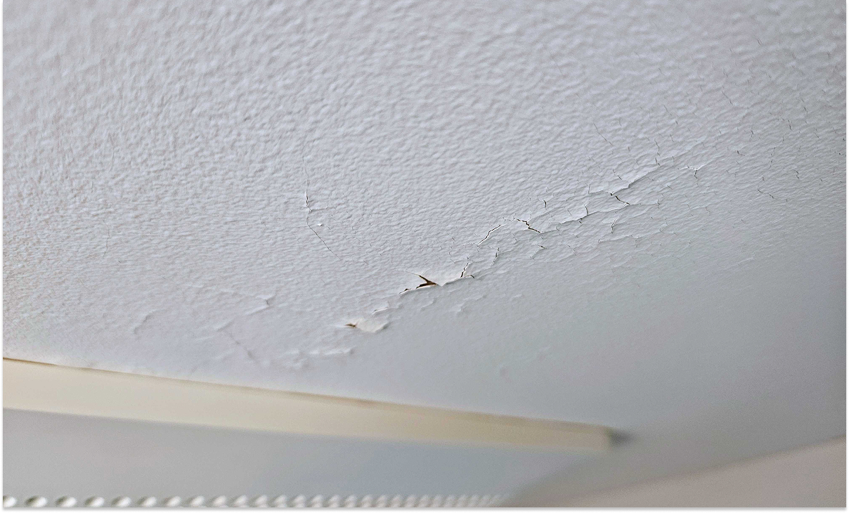 picture of flaking and cracking in a bathroom ceiling