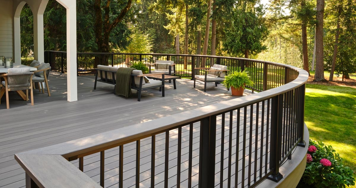 Deck with black railings and a brown drink rail in TimberTech Advanced PVC Castlegate color