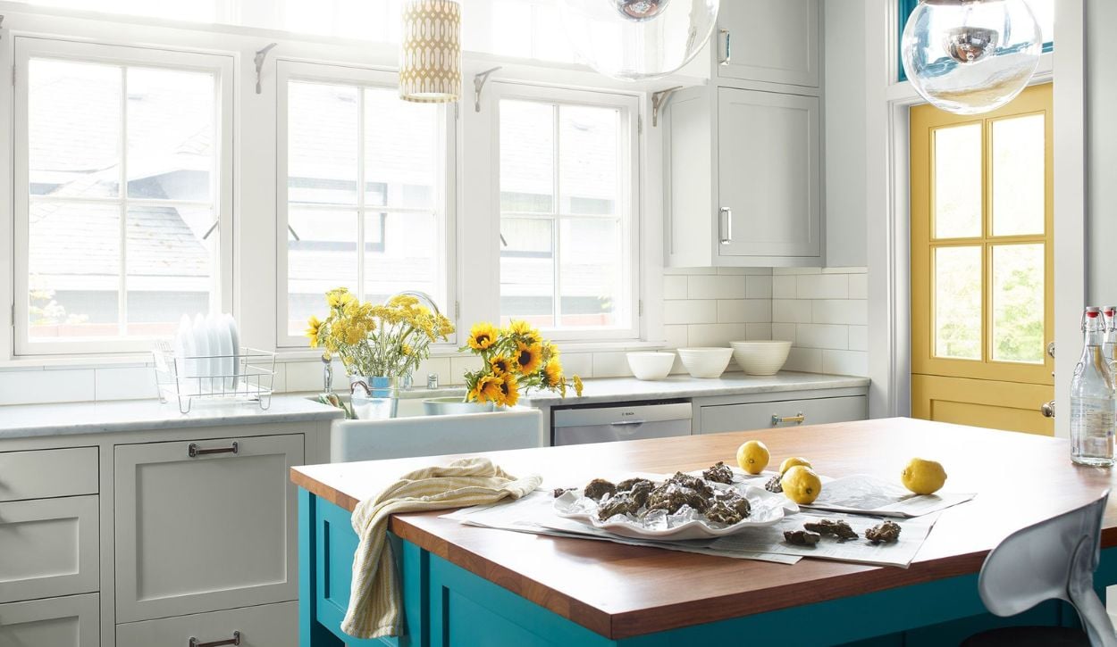 Benjamin Moore Owl Gray OC-52 kitchen cabinetry with a turquoise island and yellow accents
