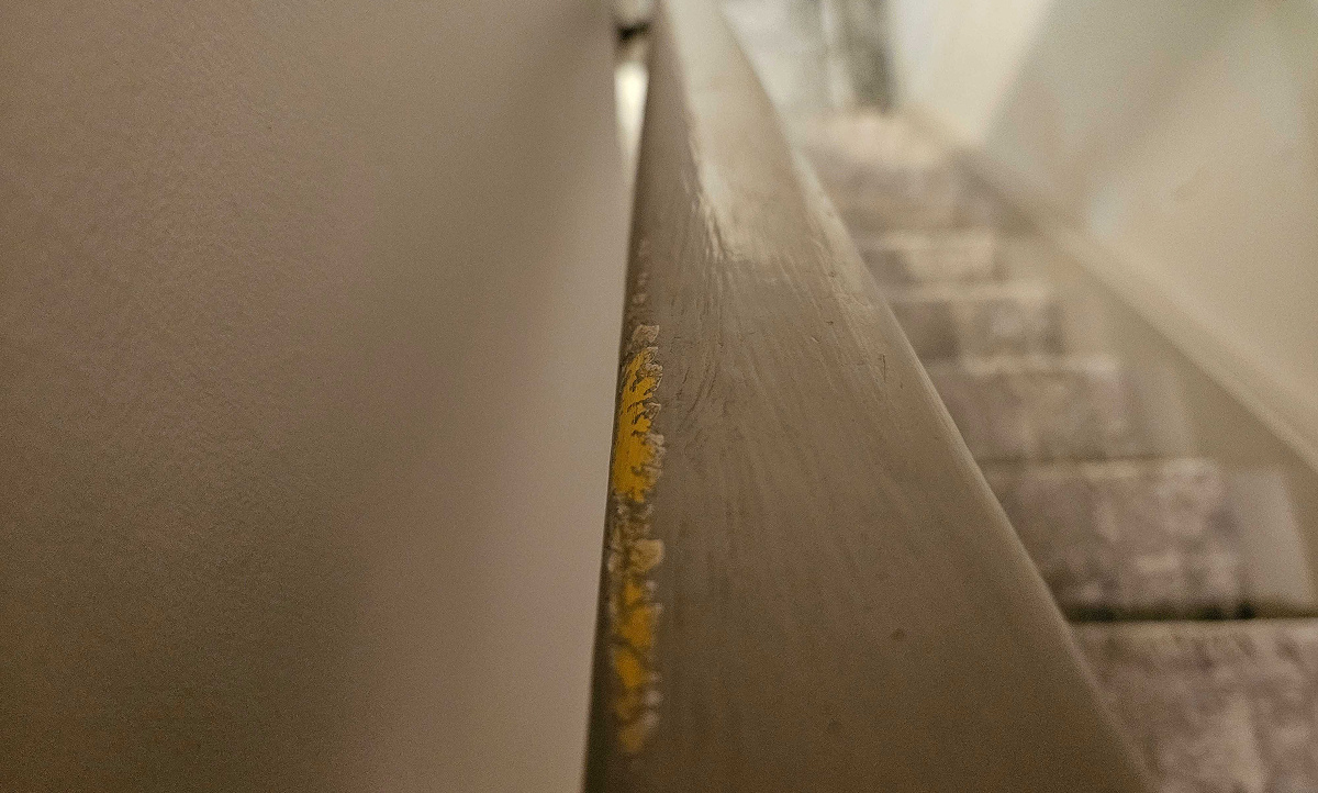 picture of peeling paint on a hand rail