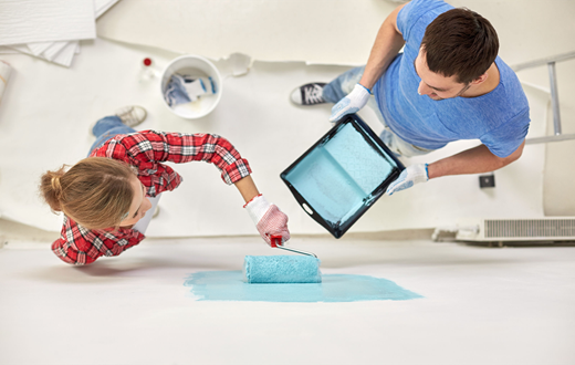 Homeowners painting a wall